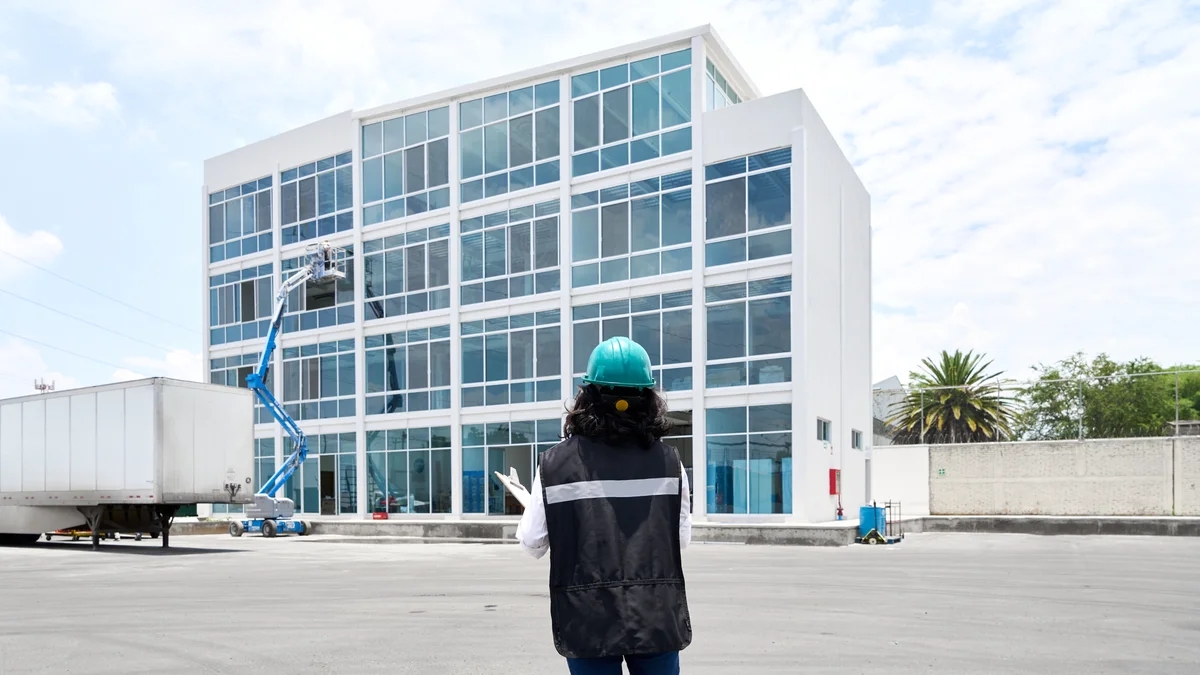 An engineer holds a tablet at a worksite.