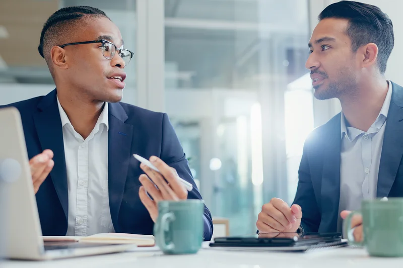 A professional holds a business report with charts.