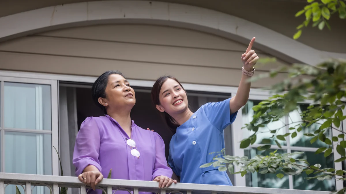 Medical staff greet one another in a corridor.
